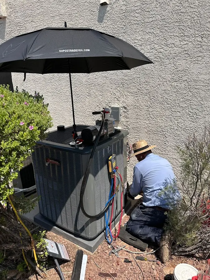 HVAC technician performing outdoor AC maintenance in Canandaigua